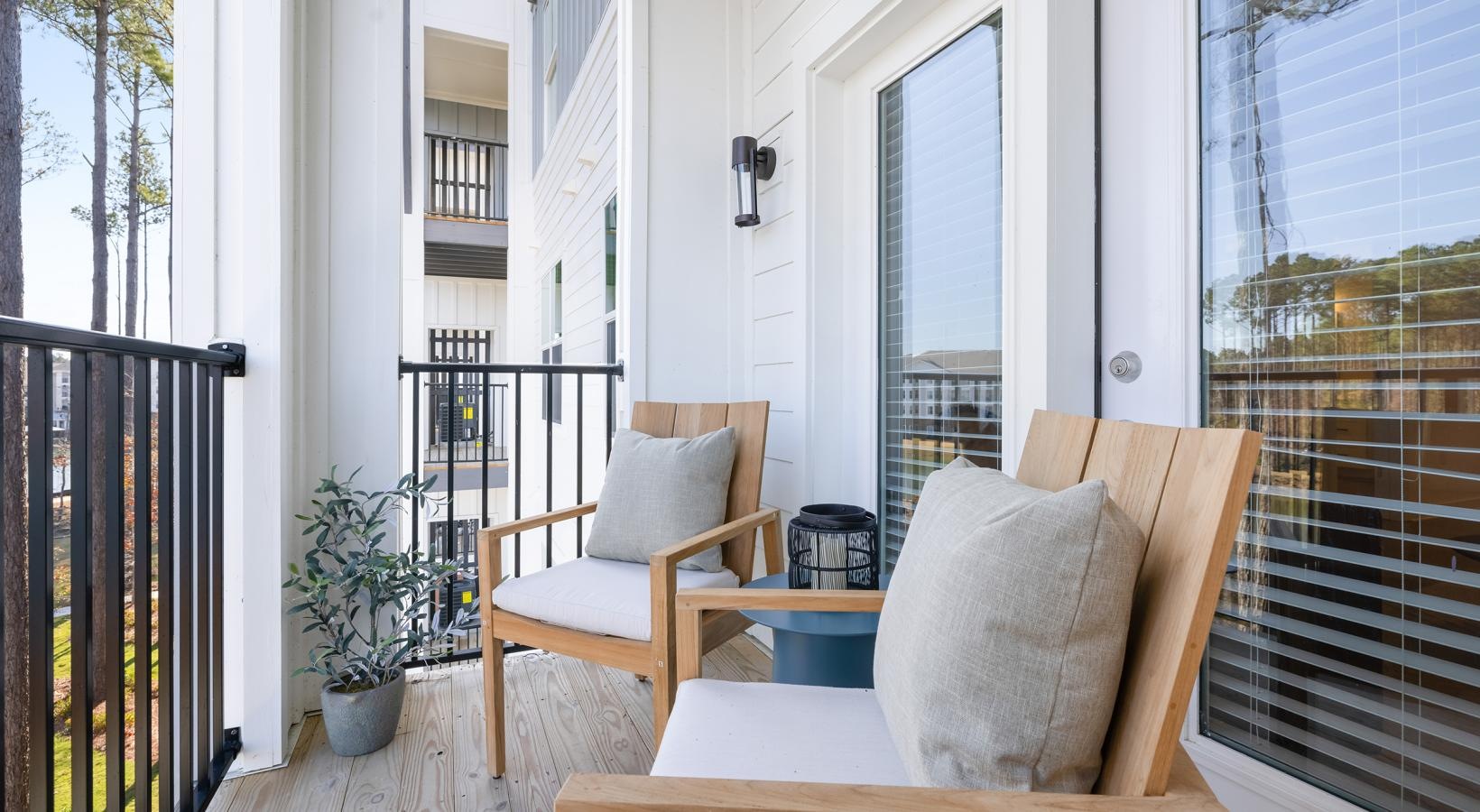 Spacious balconies a room with a table chairs and a window with blinds