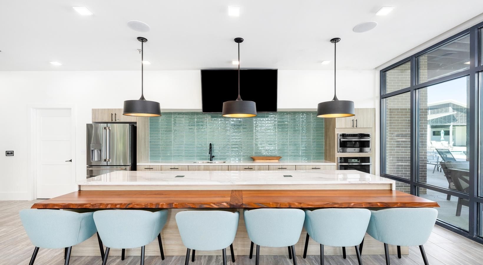 Access to resident-only features a kitchen with a bar and chairs